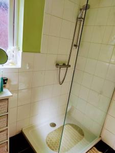 a shower with a glass door in a bathroom at House - Alton Towers,Peak District,Wildlife Park in Leek