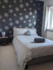 a bedroom with a bed with a black and white wallpaper at House - Alton Towers,Peak District,Wildlife Park in Leek