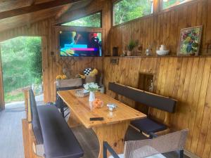 a dining room with a wooden table and chairs at Green View 1 in Skrino