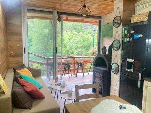 a living room with a couch and a stove at Green View 1 in Skrino