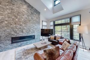 a living room with a couch and a brick wall at Beaver Creeks Meadows Ski-In Ski-Out in Beaver Creek