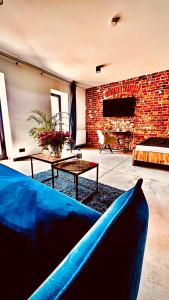 a blue couch in a living room with a fireplace at Apartamenty Gliwice Staromiejska 65 in Gliwice