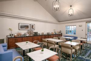 a restaurant with tables and chairs and a counter at Half Moon Bay Lodge in Half Moon Bay