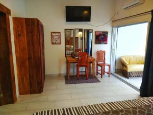 a living room with a table and chairs and a couch at Casa Río Cuale and River Retreat in Puerto Vallarta