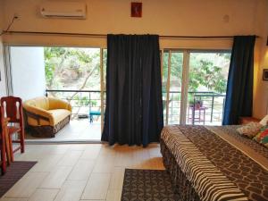 a bedroom with a bed and a sliding glass door at Casa Río Cuale and River Retreat in Puerto Vallarta