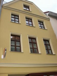 a yellow house with eight windows on it at Apartment Wittenberg in Lutherstadt Wittenberg
