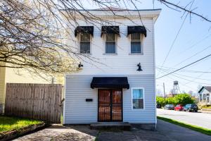 ein weißes Haus mit einer roten Tür in der Unterkunft Derby City Urban Oasis in Louisville