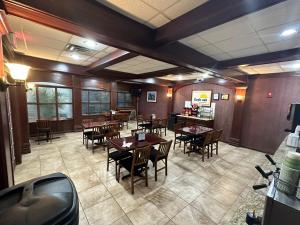 an empty dining room with tables and chairs at Days Inn & Suites by Wyndham Jennings in Jennings