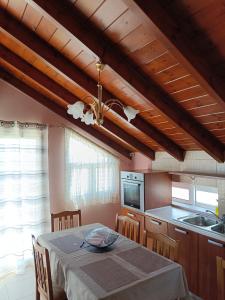 a kitchen with a table and a dining room at Apartment Batolios in Agios Georgios