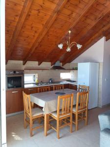 a kitchen with a table and chairs and a refrigerator at Apartment Batolios in Agios Georgios +31 photos