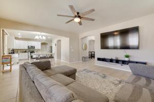 a living room with a couch and a flat screen tv at Pool, Fire Pit Family Home in Goodyear! in Goodyear