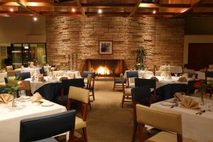 a dining room with tables and chairs and a fireplace at Four Points by Sheraton Ventura Harbor Resort in Ventura
