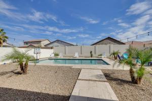 a swimming pool with palm trees and a basketball hoop at Pool, Fire Pit Family Home in Goodyear! in Goodyear