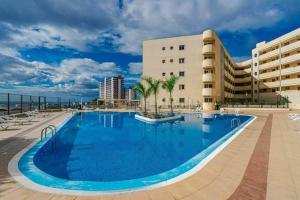 a large swimming pool in front of a building at Beautiful Apartament Sol Paraiso BALCONY& SEA POOL in Adeje