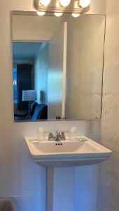 a bathroom with a sink and a mirror at Ocean Cove Motel in Virginia Beach