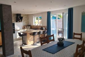 a kitchen with a table and some chairs and a counter at Domaine des Gites du Nord - L'Intemporel - 4 à 5 chambres entre Lille, Arras et La Belgique in Chemy
