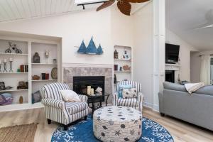 a living room with two chairs and a fireplace at 2932 Captain Sams in Johns Island