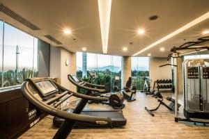 a gym with treadmills and ellipticals in a room with windows at Four Points by Sheraton Puebla in Puebla