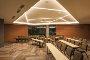 a conference room with tables and chairs in it at Four Points by Sheraton Puebla in Puebla