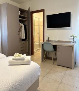 una camera con letto e scrivania con TV di La Villetta del Golfo a La Spezia