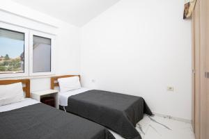a room with two beds and a window at Pjescana Uvala Sea View Apartment in Pješčana Uvala 