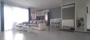 a living room with a couch and a table at Stefania Sweet Apartament in Oradea