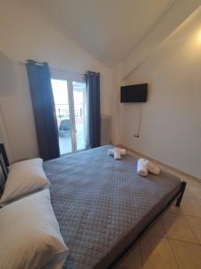 a bedroom with a bed with two towels on it at Johanna Sea View Apartment in Lixouri