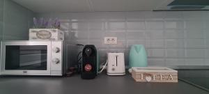 a kitchen counter with a microwave and other kitchen items at Stefania Sweet Apartament in Oradea +7 photos