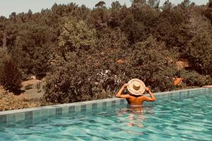 a person wearing a straw hat in a swimming pool at Pena De Roca in Pontevedra