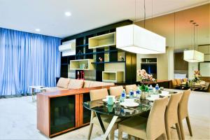 a dining room and living room with a table and chairs at Saba Suites at Platinum KLCC Bukit Bintang Kuala Lumpur in Kuala Lumpur
