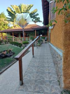 a wooden bench in front of a building at Pousada Lua e Sol in Estancia do Castello