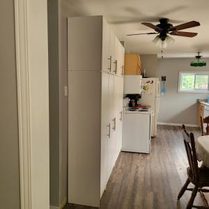 a kitchen with white cabinets and a white refrigerator at Michaels Bay Getaway on Manitoulin Island in South Baymouth