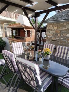 a table and chairs sitting on a patio at VENUS GUESTHOUSE in Portariá
