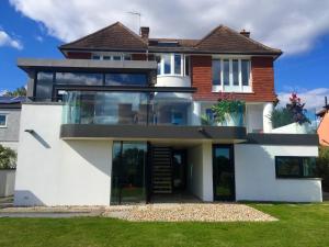 a house with a large glass facade at The Seahorse Torbay in Torquay