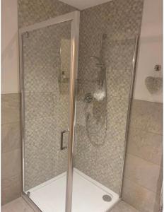 a shower with a glass door in a bathroom at Burwood House 