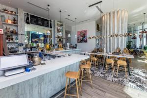 a restaurant with a bar with stools at Seashore Resort #3805 - 2 BEDROOM RIGHT ON THE BEACH DIRECT OCEAN-VIEW WITH AMENITIES ON THE ROOFTOP in Hollywood