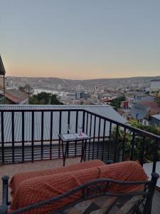 uma varanda com uma mesa e vista para a cidade em Historia y comodidad em Valparaíso