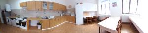 a kitchen with wooden cabinets and a white refrigerator at Prázdninový dům Sloup - Sloup v Čechách in Sloup +30 photos