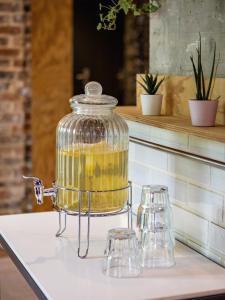 a glass jar filled with yellow liquid on a counter at Hôtel Blanca - Orso Hotels in Paris