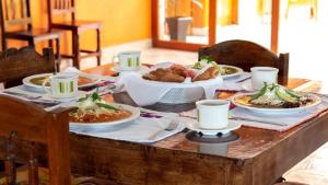 a wooden table with plates of food on it at Hotel Mixti in Cuetzalán del Progreso