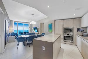 a kitchen and dining room with a table and chairs at The Ultimate Resort #2904 - BEACHFRONT 2 BEDROOM APARTMENT WITH DIRECT OCEAN VIEW, ROOFTOP POOL, HOT TUB AND GYM in Hollywood