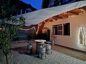 a patio with a table and some lights at Bunloc House in Braşov