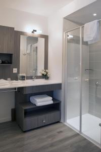 a bathroom with a sink and a shower at Domitys Le Ruban d'Azur in Sète