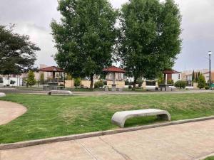 a park with three benches in the grass at Casa acogedora frente a parque 2000 pegaso, Frac. Las Misiones 1 in Toluca