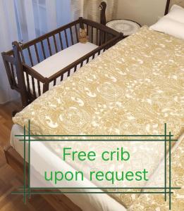 a bed with a free crib upon request at Cozy apartment Ljubljana with free parking and balcony in Ljubljana