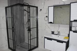 a bathroom with a shower and a sink at Mirayim Apart & Otel in Ardeşen +24 photos