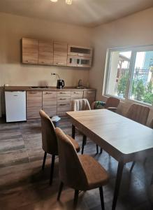 a kitchen and dining room with a table and chairs at City Hostel in Skopje