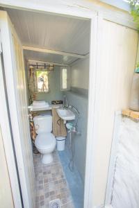 a small bathroom with a toilet and a sink at Traditional family villa southern lefkada in Sívros