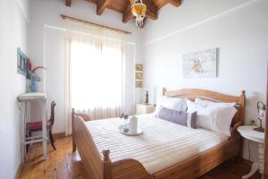 a bedroom with a bed and a window and a sink at Traditional family villa southern lefkada in Sívros