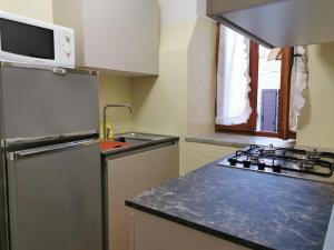 a kitchen with a refrigerator and a stove top oven at Old Town House in San Romano